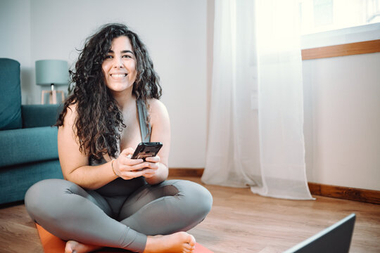 Smiling Young Woman Using Phone At Home