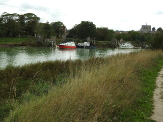 View of the town, river, boats, trees and path