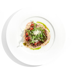 Meat medallions with mushroom creamy sauce and rucola salad on white background. Meat steak on mushroom gravy with tomato and rocket salad. Roasted beef fillet with vegetables salad in restaurant menu