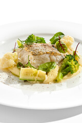 Roasted cod with mashed potatoes and broccoli. White fish fillet with skin with vegetables isolated on white background. Healthy food in restaurant menu. Fish and cabbages in minimalism style.