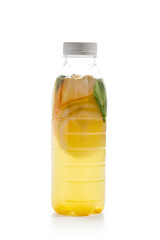 Orange lemonade in plastic bottle isolated on white background. Detox water with orange, mint and ginger. Nonalcoholic cocktail in bottle. Take away drink. Homemade lemonade.