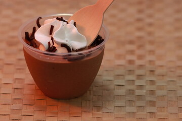 Delicious chocolate mousse cup in texture background