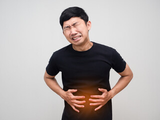 Asian man hold his belly feels very stomach ache isolated