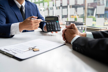 Negotiating home purchase prices, employment contracts, real estate agents, contract documents, home loan insurance and approving purchases for customers with house designs and keys on the table