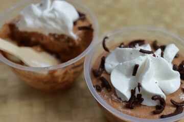 Delicious chocolate mousse cup in texture background