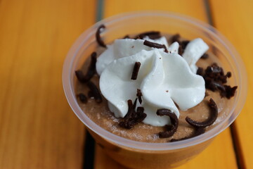 Delicious chocolate mousse cup in texture background