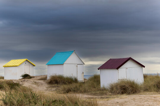 Beach cabins in Gouville sur Mer, Manche, Normandy, France in various lights