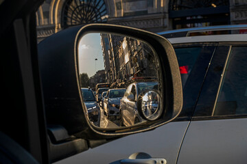 reflection of huge traffic with a police car in the right car mirror in the evening in a million million city Traffic