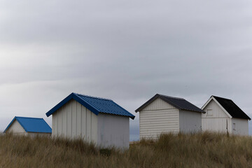 Beach cabins in Gouville sur Mer, Manche, Normandy, France in various lights