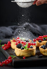 Round mini fruit pie on a wooden board