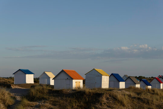 Beach cabins in Gouville sur Mer, Manche, Normandy, France in various lights