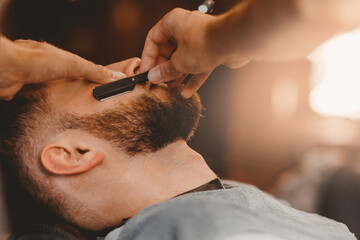 Barber hairdresser steams skin of man face before dangerous shave with razor. Barbershop concept...