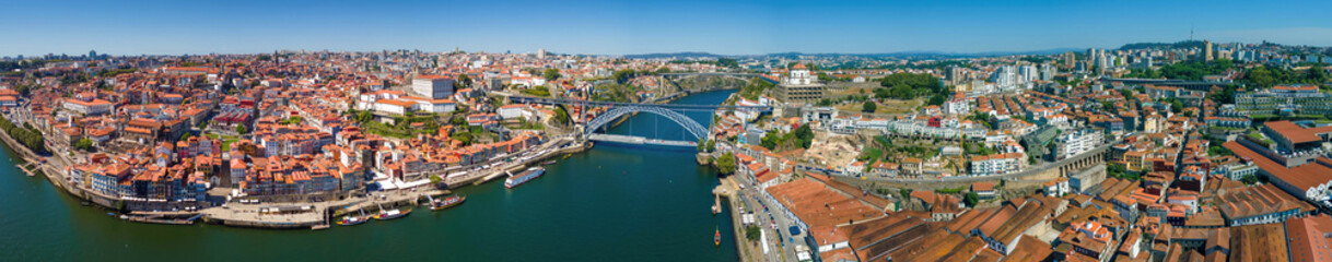 Fototapeta na wymiar An aerial panoramic view of Porto and the Douro River with bridges 