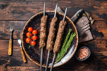 Grilled Shish kebab on skewers from minced lamb beef meat, Lula kebab. Wooden background. Top view