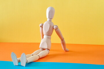 Concept of a tourist resting on the shore of the beach enjoying his vacation with an articulated wooden doll