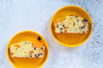 sliced homemade Apricot Blueberry pound cake on yellow plate..