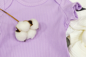 cotton flower lies on bodysuit for newborns. pure cotton baby clothes