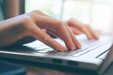 close up of female hand touching keyboard,using laptop at home