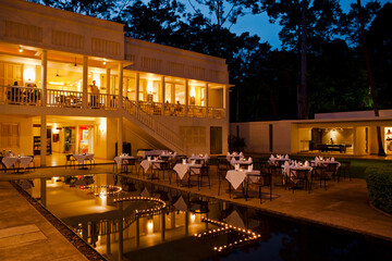 At dusk, an Angkor Wat hotel is set for dinner, Siem Reap, Cambodia.
