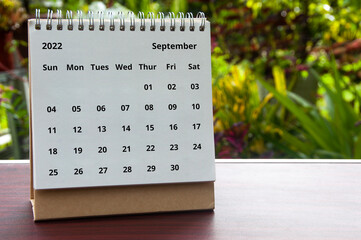 September 2022 white calendar with blurred nature background. Copy space