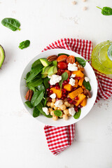 Overhead view of avocado and pumpkin slice salad healthy food - 527346364