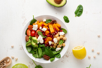 Overhead view of avocado and roasted pumpkin slice salad healthy food