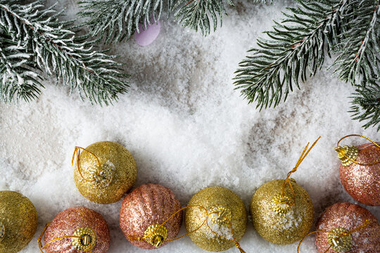 Christmas concept with snow and decorations pink and golden ball copy space top view space for text