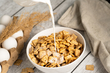 Corn flakes whith milk on the wooden table  