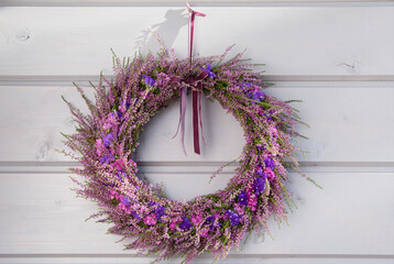 Autumn purple heather wreath decorating front door. Autumn fall concept