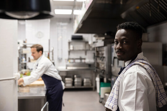 Portrait of confident chef standing in kitchen of restaurant