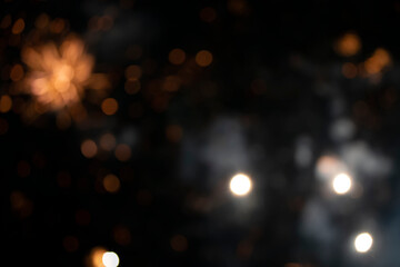On a black background bokeh from explosions of colorful fireworks.