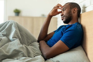 African American Man Thinking Touching Head Having Problems In Bedroom