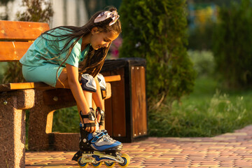 Little girl in roller skates at a park.