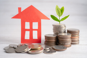 House model with growing plant on stack of coin money, home loan, saving plan, installment payment finance and banking concept.