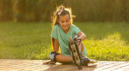 little cute happy girl rollerblading through the city streets