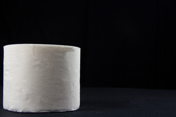 White toilet paper roll on a black background
