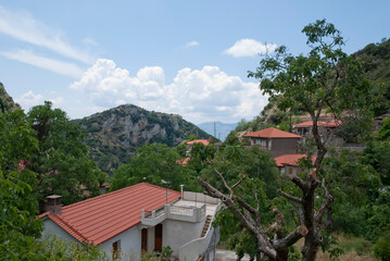 Fototapeta na wymiar Stemnitsa, Greece / July 2022: Historic traditional village at the slopes of Mainalon mountain in the Peloponnese.