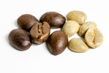 roasted and unroasted coffee beans on white background