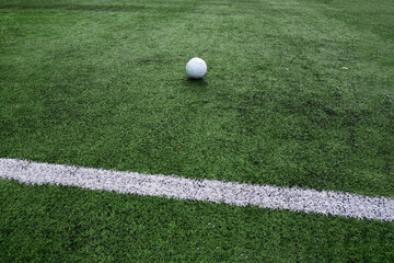 Close up of football field markings and a ball