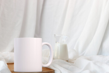 Fototapeta na wymiar White coffee mug mockup, on a wooden board. Perfect for using to sell custom printed mugs.
