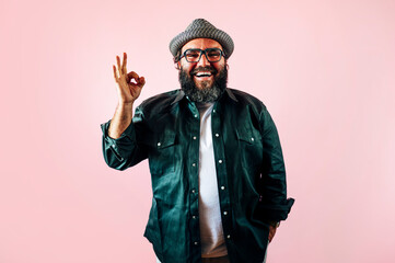 Fat man with a beard and doing the OK sign.