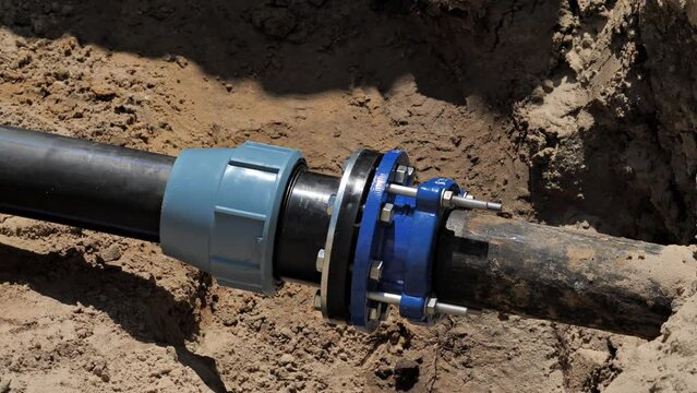 Repair of an underground pipeline of a water or sewer system. Replaced new pipe connection.