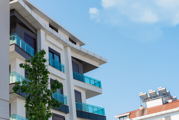 The exterior of an apartment building against the sky.