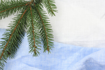 New Year's Eve holiday tablecloth on the table and a branch of spruce.