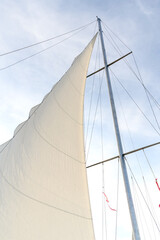 White sails in the blue sky. Travel by boat on the sea.