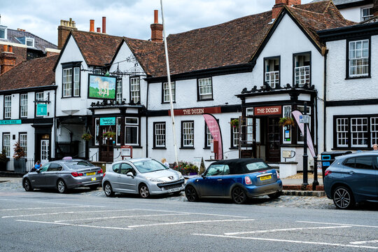 Traditional High Street Public House With Cars Parked
