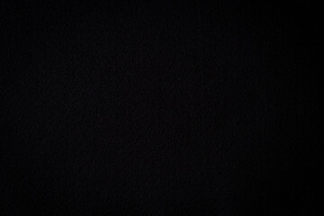 Black color felt textile fabric material texture background. Abstract monochrome black color background