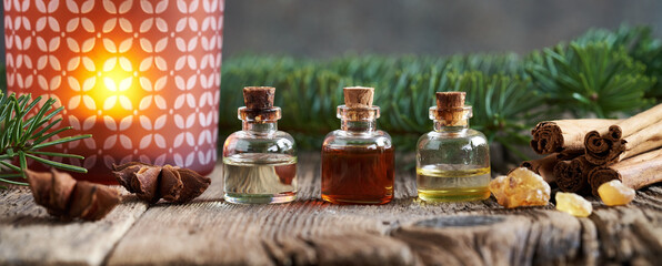 Christmas banner with essential oil bottles, frankincense, cinnamon, fir