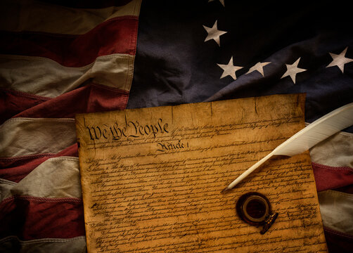 Original 13 star American flag with Declaration of Independence and ink bottle with quill pen