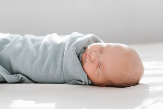 Newborn boy (0-1 months) sleeping on bed